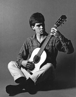 Paul Galbraith seated with a six-string guitar by David Rubio.
